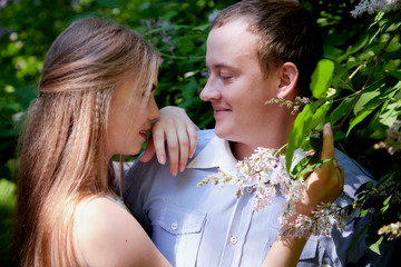 Obraz premium Young man and woman couple walk in the park. Spring or summer love story. Young happy family