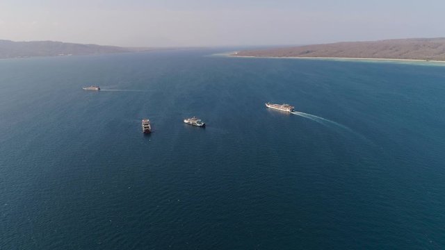 public ferry ships carrying passengers from Gilimanuk harbour ferry port in Bali Island to Ketapang harbour East Java, Indonesia