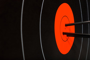 Three arrows in the center of black and red archery target. Accuracy and precision concept.