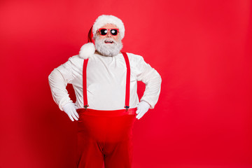 Fototapeta na wymiar Party eve noel time midnight concept. Photo of cheerful optimistic grey-haired glad nice handsome trendy modern confident in sunglass trousers pants suspenders father spirit isolated bright background