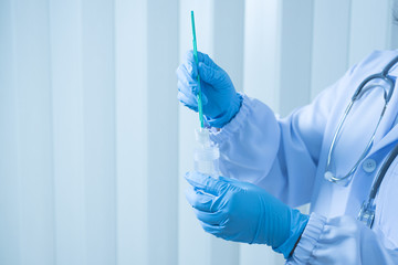 Doctor hand holding liquid base cytology set on blue background.Gynecologist working for vaginal and cervix pap smear patient in the obstetrics and gynecology department.Medical concept. - obrazy, fototapety, plakaty