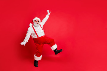 Fototapeta na wymiar Full length photo of fat overweight santa claus with big funny belly abdomen have eyeglasses dancing wearing trousers pants boots isolated over red background