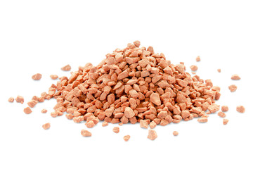 Heap of red mineral fertilizers on a white background. Potassium chloride is isolated on a white background. Granules of mineral fertilizer - potassium chloride.