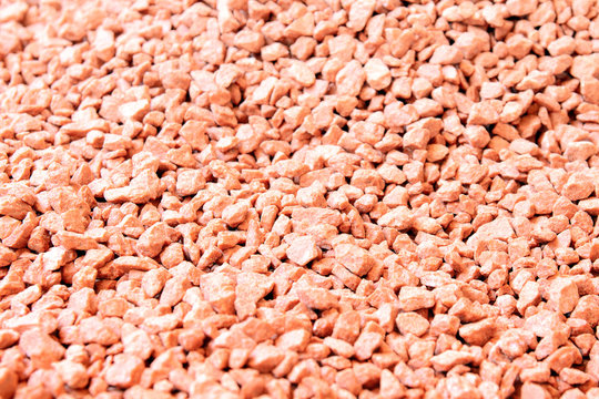 Potassium chloride is a red mineral fertilizer close-up. Red background of fertilizer potassium chloride. The texture of granular potassium chloride is red.