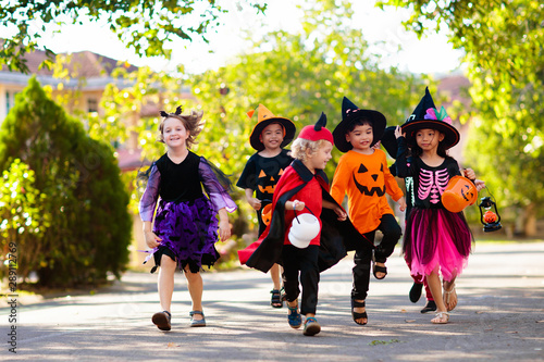 Kids trick or treat. Halloween fun for children.