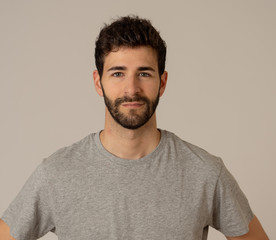 Natural portrait of young attractive man in his 20s looking and posing with neutral face expression