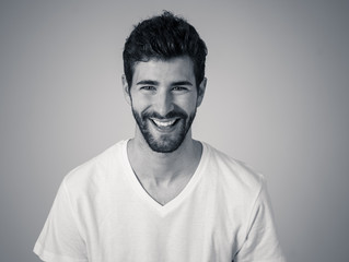 Portrait of attractive cheerful young man with smiling happy face. Human expressions and emotions