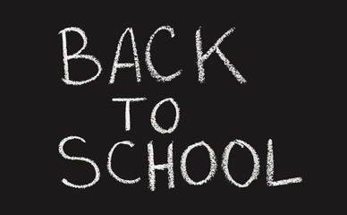 Back to school concept handwriting text with chalk on black