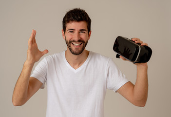 Portrait of cheerful young man wearing Virtual Reality goggles for first time smiling at camera