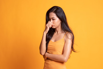 Young Asian woman  holding her nose because of a bad smell. - obrazy, fototapety, plakaty