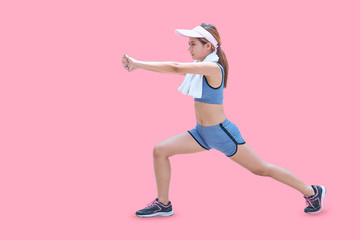 Fototapeta na wymiar Fit and healthy woman warm up before running. Asian girl on isolated pastel color background with copy space.