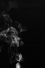 abstract fragment movement of white smoke on black background.
