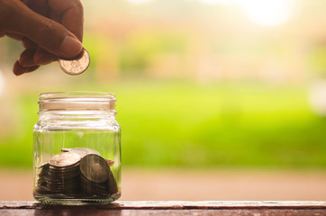 businessman putting coin in to glass jar count the money for saving concept. budgeting for investment startup business.