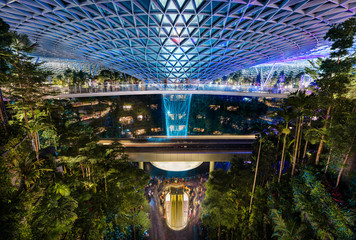 The Jewel at Changi Airport, with the rain vortex indoor waterfall illuminated during the light show, Singapore