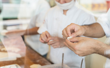 Obraz na płótnie Canvas Close up hand of chef are make Xiao long bao.It is the most popular Chinese dim sum dishes. Xiao long bao is made from bread flour mixed with wheat flour with minced pork filled with broth in the wate