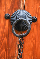 wooden door gate with vintage metal knocker.