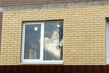 Broken window on an abandoned construction site after developer bankruptcy