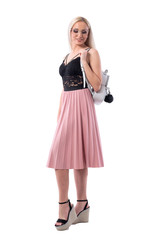 Happy smiling young fashionable woman carrying leather shiny bag on shoulder looking down. Full body isolated on white background.