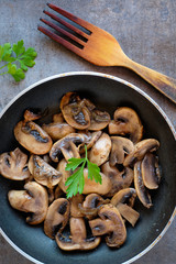 Fried mushrooms with onion on a pan