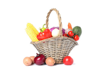 Wicker basket with vegetables isolated on white background