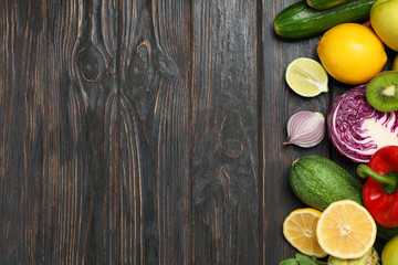 Fototapeta na wymiar Different vegetables and fruits on wooden background, copy space