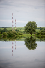 cell tower and reflections in large ponds.