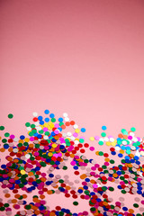 colorful confetti on pinkn background