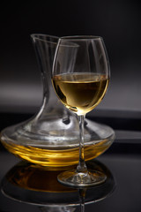 A glass full of wine and wine decanters