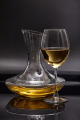A glass full of wine and wine decanters