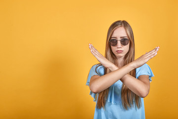 girl brunette in blue t-shirt over isolated orange background shows emotions