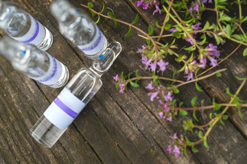 Alternative Medicine.Thyme and medical ampoules. Essential oils