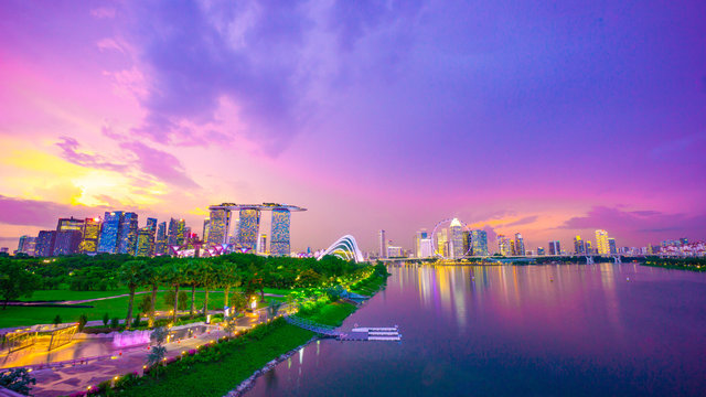 Royalty-free stock photo ID: 1488208352  Landscape of Singapore city during the twilight time and thunderbolt with marina bay sand tower, and Singapore flyer and Gardens by the Bay background. Tourist