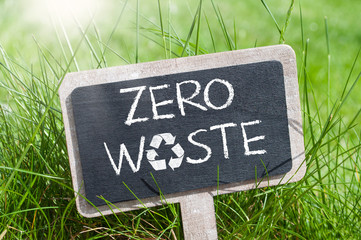 Chalkboard in the grass with zero waste and recycling logo