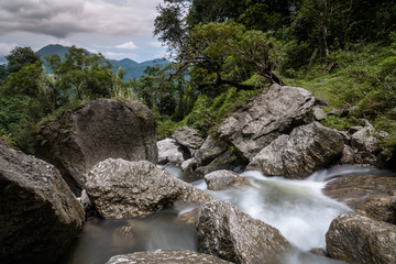 Mountain stream at Hoang Su Phi, Ha Giang, Vietnam. Silky smooth water flow slow shutter speed. Rocky river landscape. 