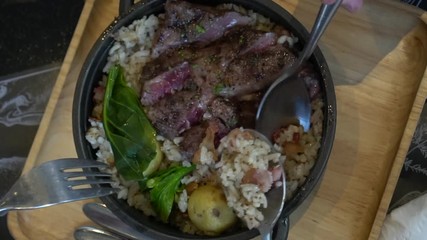 Eating medium rare wagyu beef steak over rice fusion Asian twist food