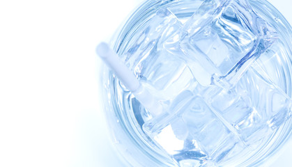 Ice cubes in the drinking water glass on white background.Cold drink cup on the food table in the restaurant.
