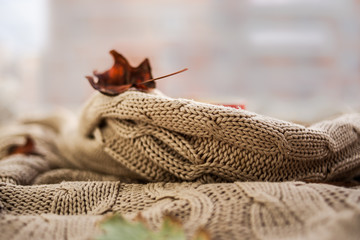 Knitted wool sweaters. Pile of knitted winter, autumn clothes knitwear.