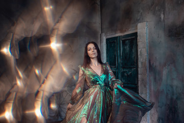 Young women are brunette, spinning and dancing in a dark room