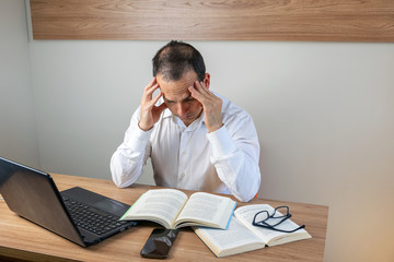 43 year old man studying and worried to make his report.