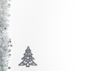 Christmas silver garland and silver trees decoration on white background.