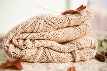 Fototapeta na wymiar Knitted wool sweaters. Pile of knitted winter, autumn clothes knitwear.