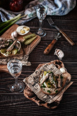 fish snack with cucumbers and boiled egg. filed on newspapers and boards