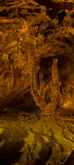 Nguom Ngao cave in North Vietnam, Cao Bang province. Enormous stalagmites and reflecting water pools. Vietnamese landscape. 