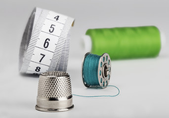 sewing set from a thimble of colored thread and a centimeter