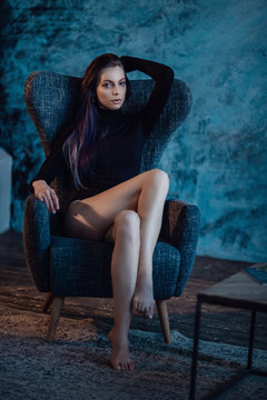Beautiful young woman with black turtleneck posing in a stylish room