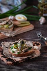 fish snack with cucumbers and boiled egg. filed on newspapers and boards