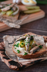 fish snack with cucumbers and boiled egg. filed on newspapers and boards