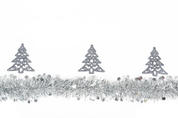Christmas silver garland and silver trees decoration on white background.