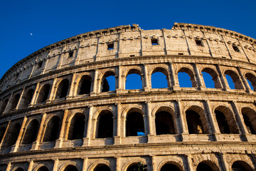 Fototapeta premium The famous Colosseum under the beautiful light of the golden hour in Rome
