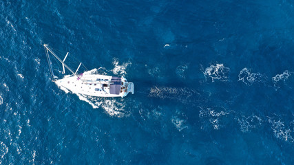 Aerial drone photo of luxury sail boat cruising in the deep blue Aegean sea, Greece